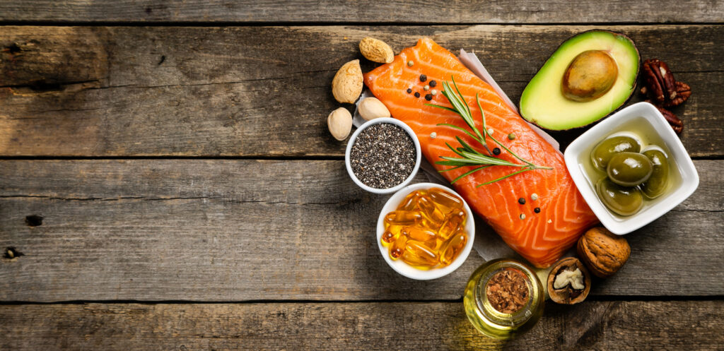 omega-3-rich foods like salmon, chia seeds, and avocados on a wooden table