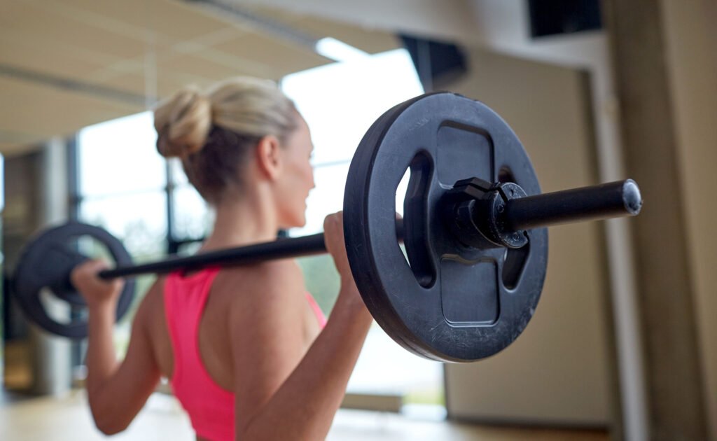 a woman lifting weights at the gym