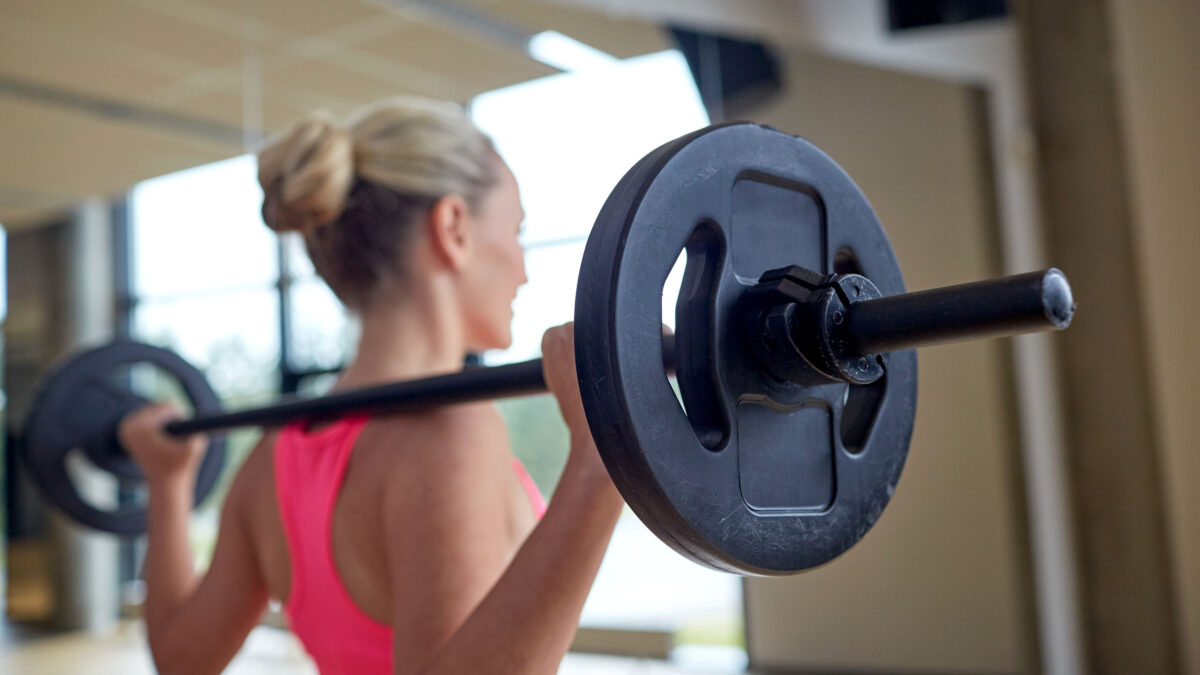 a woman lifting weights at the gym