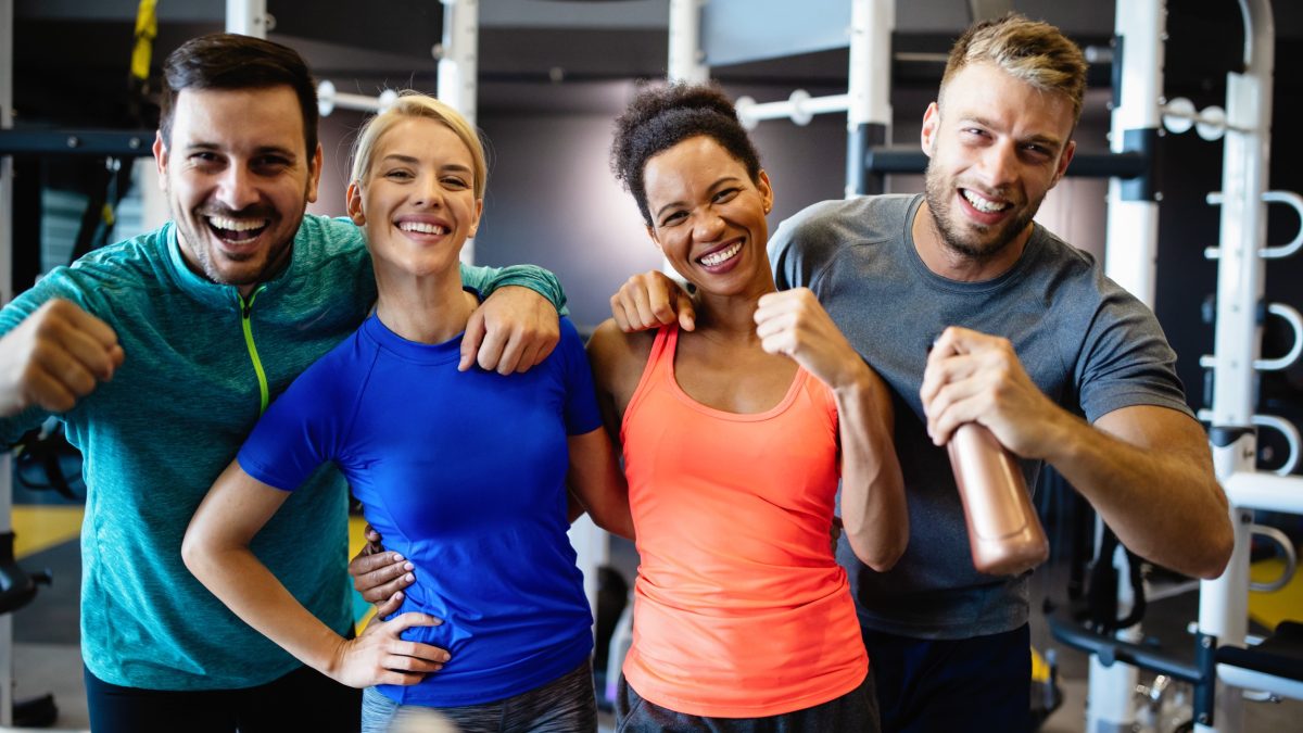 Happy adults smiling while working out