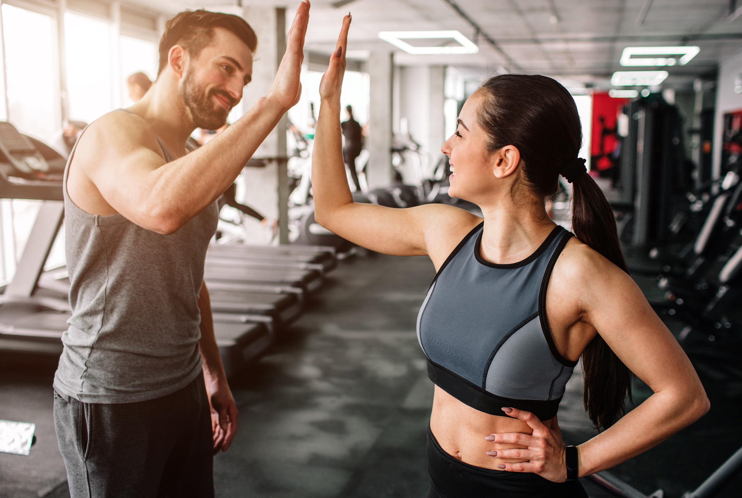 Couple giving each other a high five after a partner workouts.
