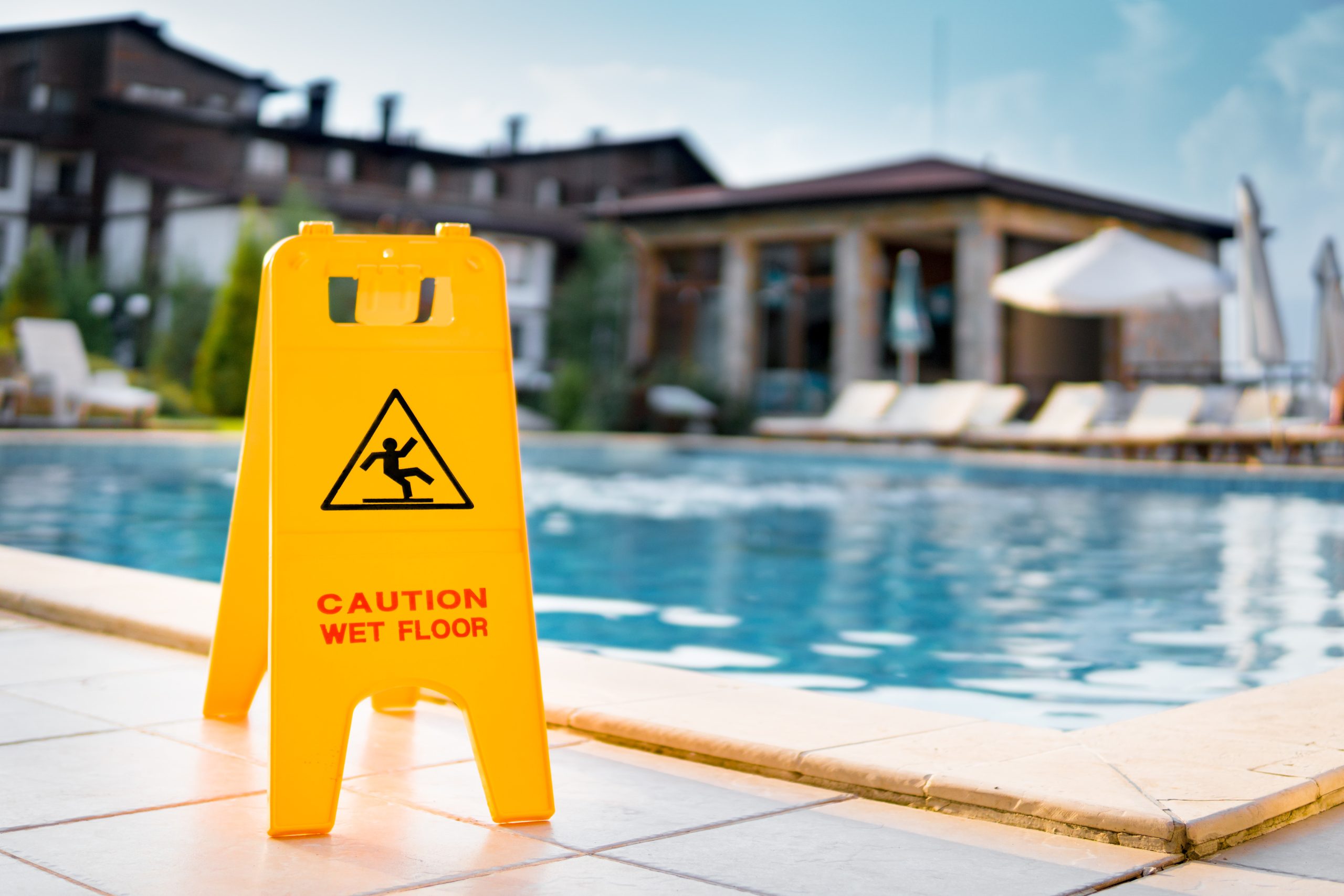 Wet floor sign next to pool
