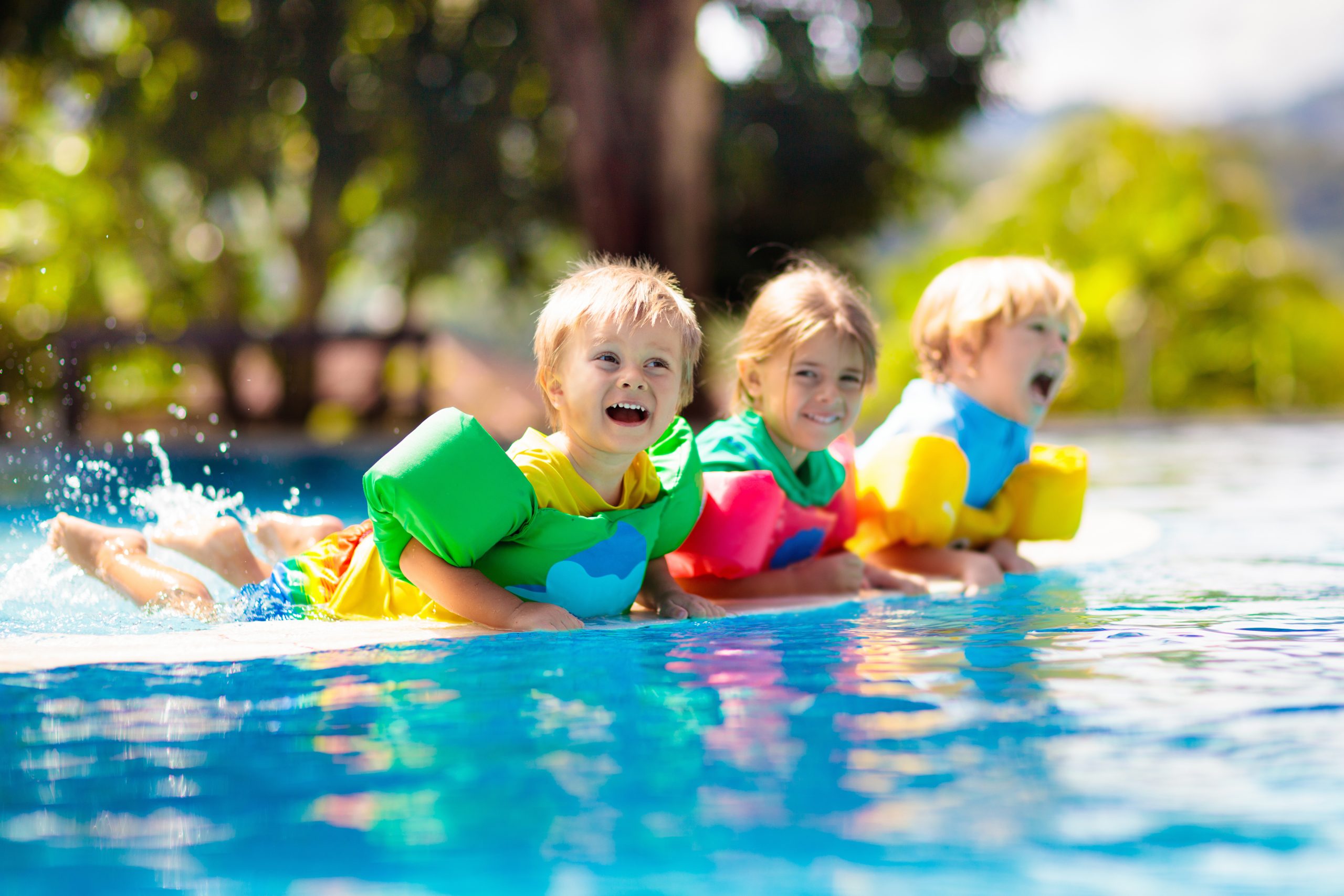 Kids with floaties playing in pool